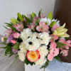 Lovely pastel-colored arrangement of carnations, alstroemerias, lilies, and daisies.