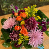 Colors of Orange, Purple, Yellow and Gold grace this beautiful arrangement.
This gorgeous