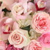 A romantic arrangement of blush, white and lavender flowers in a clear