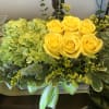 Green hydrangea with yellow roses in a wooden box 