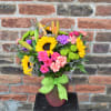 A bouquet bursting with bright, summer colors! Yellow sunflowers, green button mums
