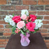 A bouquet that is bright and sweet....hot pink roses, coral hypericum, babysbreath