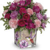 Like a hummingbird flitting around a secret garden, this delightful bouquet of