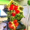 A beautiful 12 red roses and pink roses with baby&#039;s breath, greenery