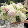Light colors and pink w gorgeous vibrant  peonies roses and hydrangea.