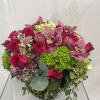 A nice assortment of Roses, Orchids, Hydrangea &amp; seasonal greens in watermelon