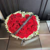 17 roses surrounded with babies breath in the shape of a heart.