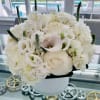 A sophisticated and refined all-white floral arrangement that exudes timeless beauty. This