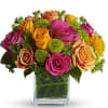 This beautiful arrangement of roses and touch of green pom Poms creates