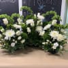 Low dish arrangements made to accommodate any urn size.