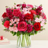 All-around arrangement with red roses, hot pink roses &amp; carnations, pink Peruvian