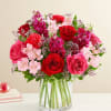 All-around arrangement with red roses, hot pink roses &amp; carnations, pink Peruvian