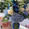 Cobalt blue case, blue dendrobium orchids, eucalyptus, white snapdragons and blue hydrangeas