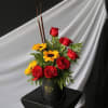A modern take on roses and sunflowers. Arranged in a black hatbox