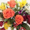 A beautiful and vibrant mixed bouquet featuring orange roses, purple calla lilies