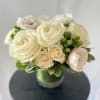 A modern, hand tied compact styled arrangement of our white blooms from