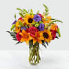Bright summer bouquet with sunflowers lilies roses in a glass vase perfect