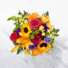 Bright summer bouquet with sunflowers lilies roses in a glass vase perfect