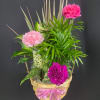 This wicker basket is filled with a combination of green plant is
