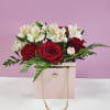 This charming arrangement features, red roses, hot pink carnation, red carnation, and
