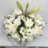 Buyer will receive a Basket with white roses, Lilly, carnations, and daisies.