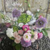 A beautiful mix of allium, lisianthus, spray roses, roses, ranunculus, hydrangea, cymbidium