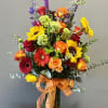 A bright colorful orange, yellow and green arrangement to brighten someone&rsquo;s day.