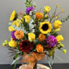 Bright beautiful fall colors arranged with sunflowers, roses, gerber daisies, fall filler