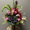 An arrangement with a modern twist of flowers intricately arranged for any