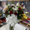 It&rsquo;s an arrangement in a vase,with red roses and a white lily