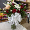 It&rsquo;s an arrangement in a vase,with red roses and a white lily