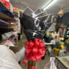 50 red  roses with three sunflower in the middle bouquet