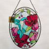 This stained glass bird scene, hanger is able to hang from a