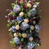 Hand selected florals on an easel makes a beautiful tribute for a