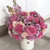 A delightful flower arrangement exuding sweetness and charm with its soft hues