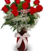 Beautiful 1 dozen red roses in a red or clear vase. ribbon