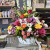 Includes a variety of flowers in a basket arrangement