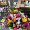 Includes a variety of flowers in a basket arrangement