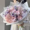A cute bouquet of fresh ranunculus, hydrangea and stock in pink and