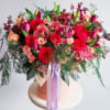 This bouquet is a total showstopper! With its fiery red roses, soft