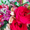 This bouquet is a total showstopper! With its fiery red roses, soft