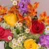 A striking colors of pink, yellow, lavender and orange flowers arranged in