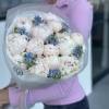 Bouquet of white peonies and blue Tweedia 