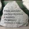 This smaller cement stone features the saying, &quot;When someone you loves becomes