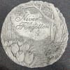 This cement stone features the saying, &quot;Never Forgotten&quot; with a nature scene