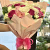 This bouquet with soft blush, deep fuchsia, and creamy white roses paired