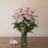 Embrace the beauty of lush lavender roses with greens and fillers in