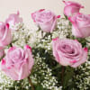 Embrace the beauty of lush lavender roses with greens and fillers in