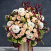 A mixed bouquet of whimsical stems and spray roses.