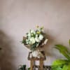 A white mixed garden bouquet with the subtlest pops of yellow create